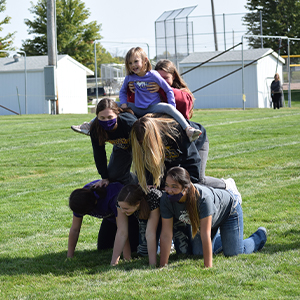 Students form a human pyramid