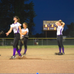 Girls softball players huddled on pitching mounc