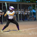 Girl hitting ball on field