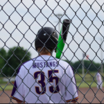 Boy in batters box with back to the fence number 35