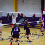 Girls returning volleyball back across the net