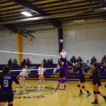 Girls on volleyball court with one setting the ball