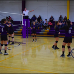 Girls on volleyball court waiting for play to begin