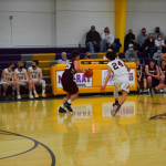 Boys basketball players playing defense