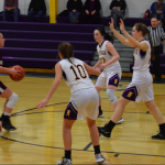 Girls basketball players playing defense