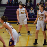 Girls basketball players in playing defense